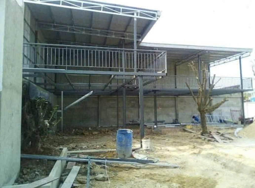 a building under construction with a metal railing