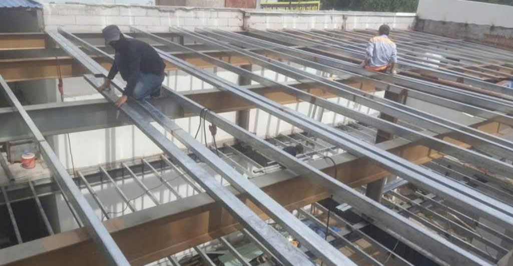 a group of men working on a metal structure